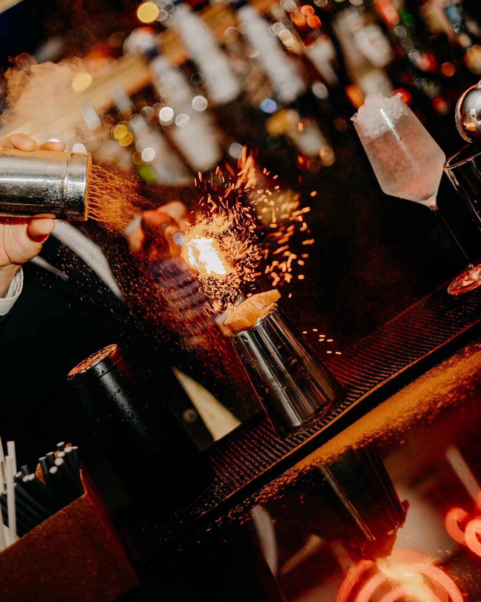 138 Liberdade Hotel Lisboa Exteriör bild A bartender using a cocktail gun to make a flaming shot